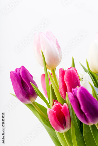 Fototapeta Naklejka Na Ścianę i Meble -  bunch of  colored tulips in a vase with white background