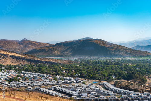View of the suburbs in the valley. Chicureo, Colina Santiago, Chile.
Houses with a hill in the background. Landscape of the northern part of Santiago photo