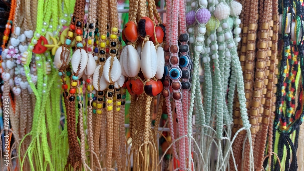 Colorful bracelets made of beads and ropes for sale at the market
