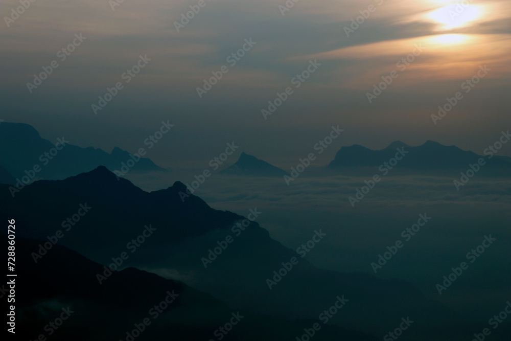 sun rise from the top of the mountains with mist