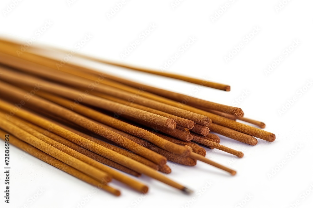 Close up of isolated brown Indian incense sticks on a white background Top view of a meditation set
