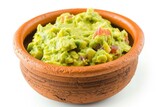 Top view of bowl with guacamole and ripe avocado on white background