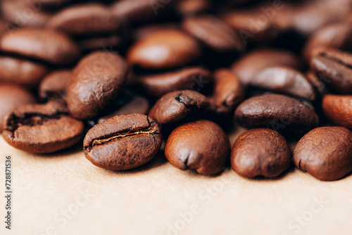 Roasted coffee beans on beige background. Closeup, copy space
