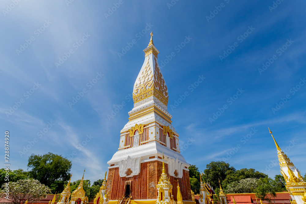 Naklejka premium White gold pagoda with blue sky as background, Wat Phra That Phanom is a Buddhist temple in the That Phanom District in the south of Nakhon Phanom Province, Isan region of Thailand near the Lao border