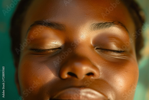 Close-up face african descent closing and opening eyes, smiling reaction.