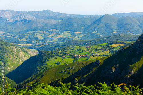 Unique summer landscape of Peaks of Europe with rocky mountain ranges and greenery on foothills, Spain photo