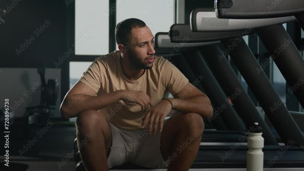 Athletic man tired exhausted African American thirsty male sportsman runner drinking water drink protein from fitness bottle refresh habit hydration in sport gym rest on treadmill run cardio exercise Athletic man tired exhausted African American thirsty male sportsman runner drinking water drink protein from fitness bottle refresh habit hydration in sport gym rest on treadmill run cardio exercise