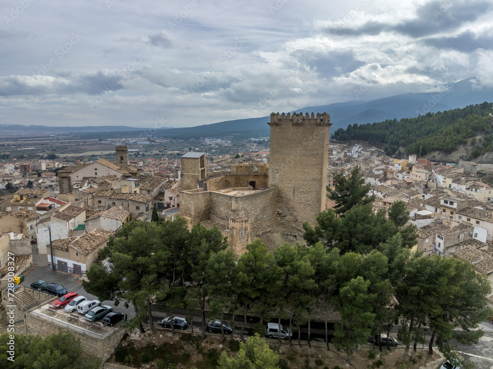 Aerial view of Moratalla castle in Murcia province Spain dominating the village with square great tower, nicely restored monument from medieval times
