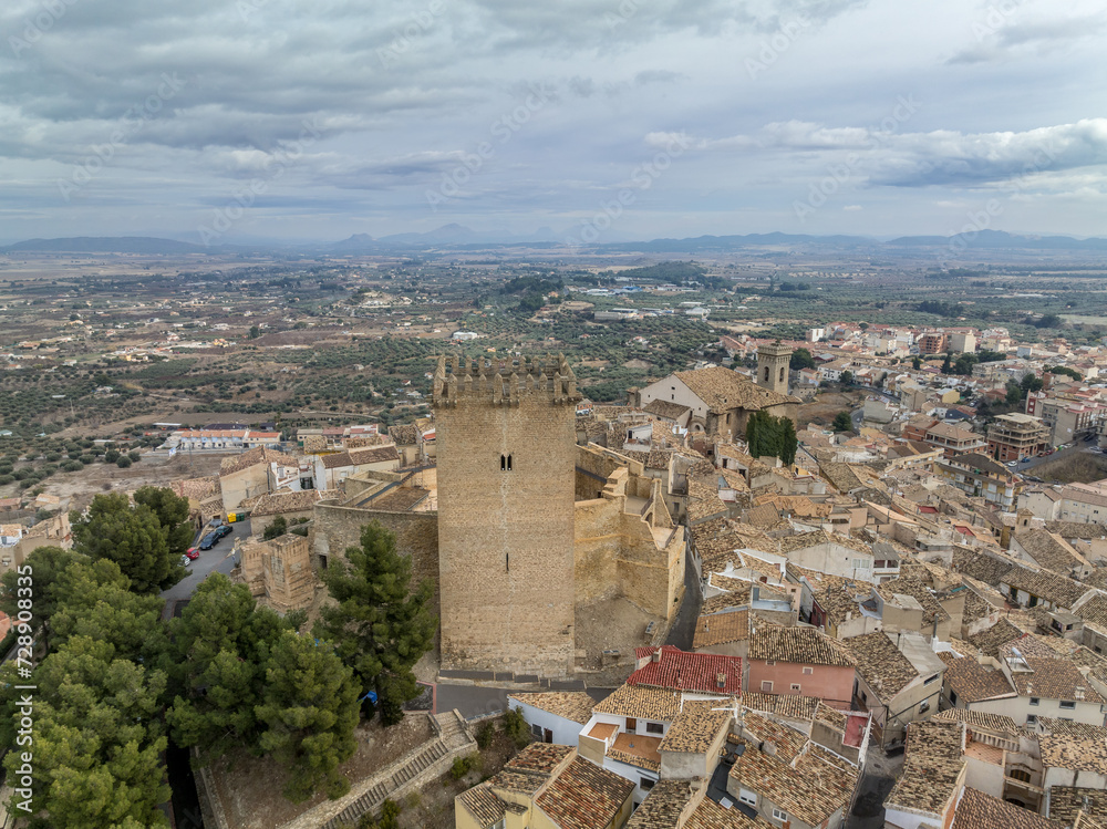 Aerial view of Moratalla castle in Murcia province Spain dominating the village with square great tower, nicely restored monument from medieval times