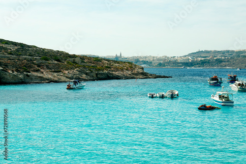 Beautiful view of rocky sea shore with boats on summer day © Pixel-Shot
