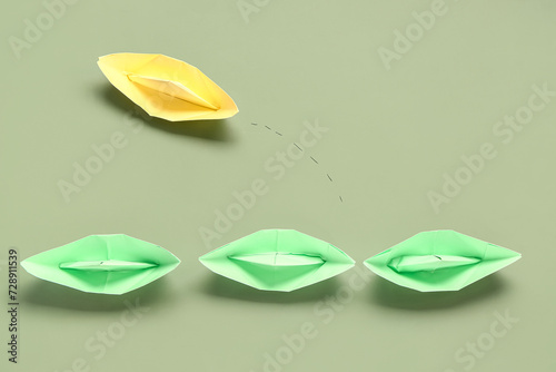Paper origami boats on gree...