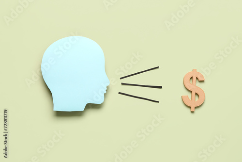Paper human head and dollar symbol on grey background. Business idea concept