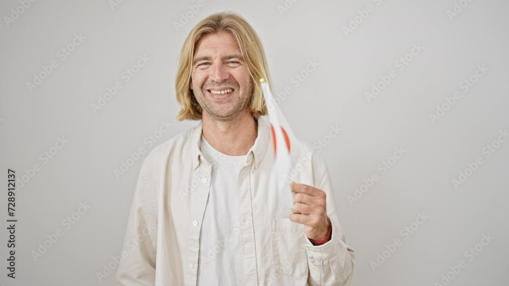 A smiling blond man holding a japanese flag against a white background.