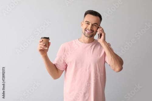 Happy young man with cup of...