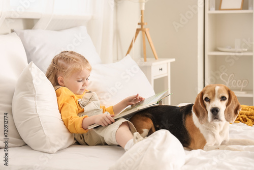 Cute little girl with book ...