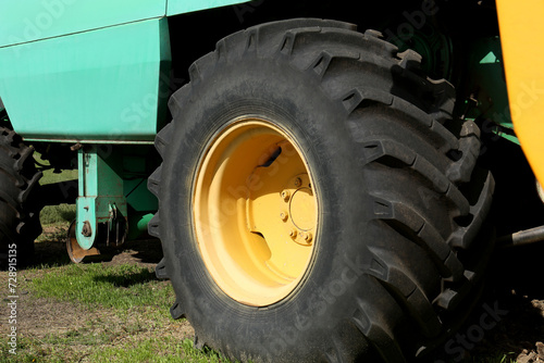 Modern combine harvester wheel outdoors, closeup view © New Africa