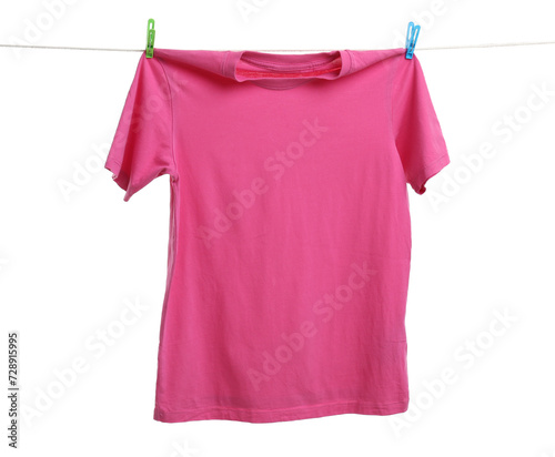 Pink t-shirt drying on washing line against white background