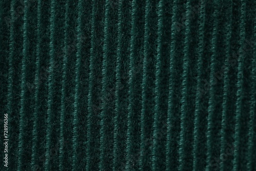 Texture of soft dark green knitted fabric as background, top view