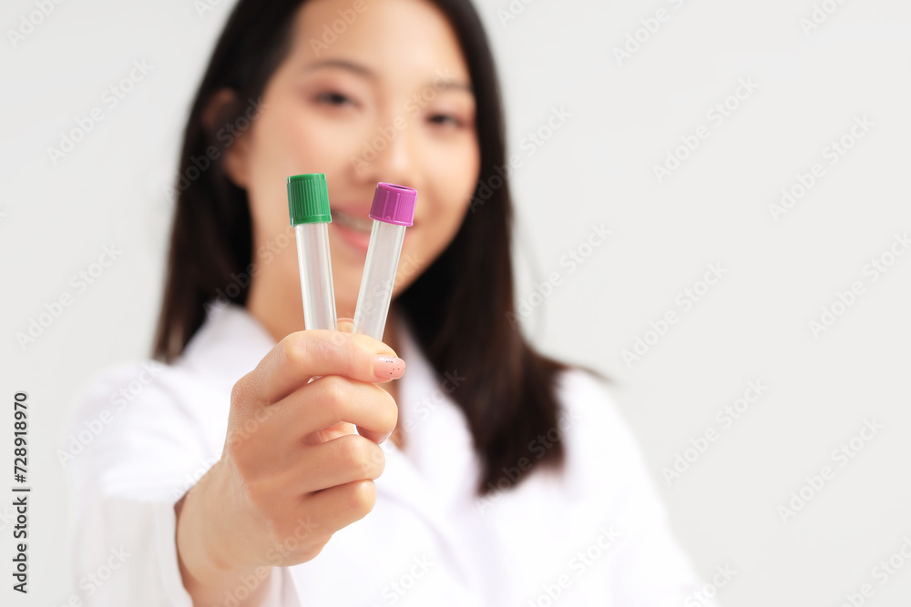 Asian woman holding empty test tubes on white background, closeup Asian woman holding empty test tubes on white background, closeup