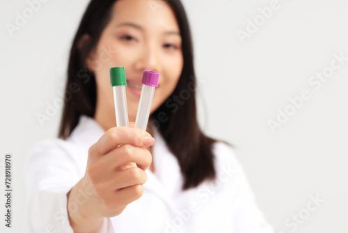 Asian woman holding empty test tubes on white background  closeup