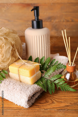 Composition with spa accessories and plant leaves on wooden background