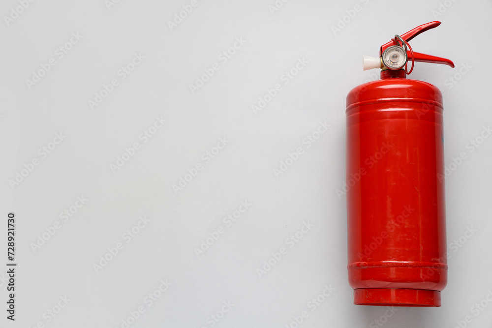 Fire extinguisher on grey background Fire extinguisher on grey background