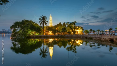 Tran Quoc pagoda in Hanoi timelapse day to night sunset.  photo