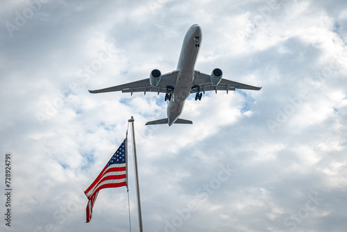 Airplane Airbus A350 flying in the sky against the background of the american flag