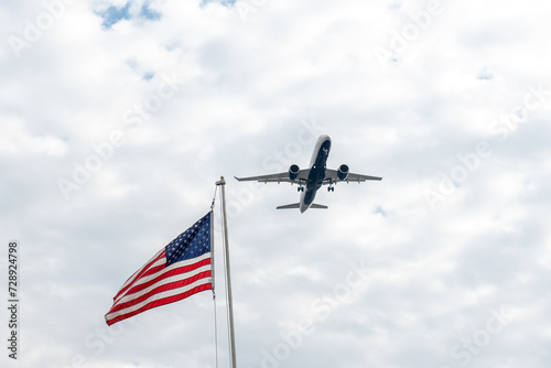 Airplane flying in the sky against the background of the american flag