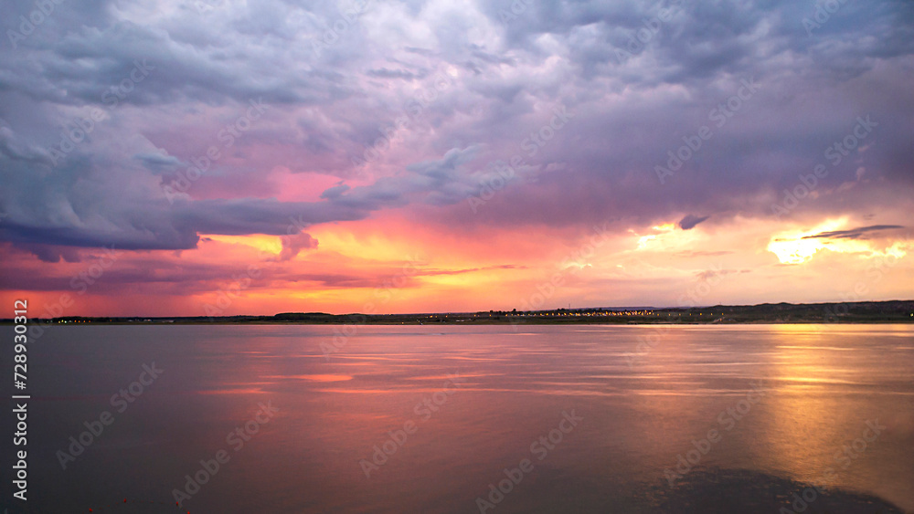 
We see an incredible sunset, in the middle of the calm of the lake, the horizon seems to catch fire, a storm in formation accompanies, the beauty of the evening. El Carrisal Mza Dam. Arg.