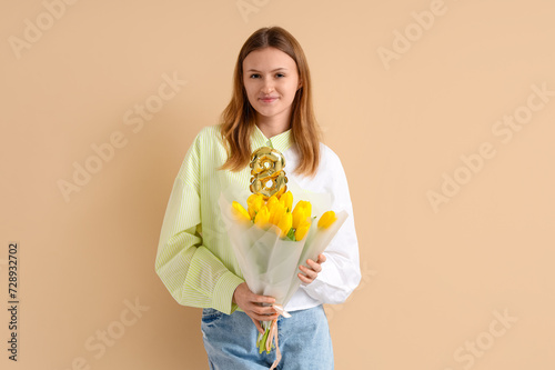 Young woman with bouquet of...