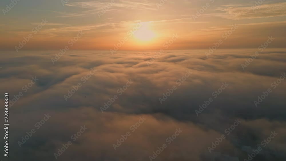 Orange sunrise shining clouds aerial view. Thick fog covering picturesque nature