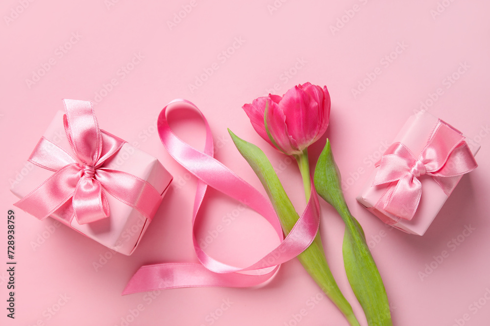 Composition with figure 8 made of ribbon, tulip flower and gift boxes on pink background. International Women's Day celebration Composition with figure 8 made of ribbon, tulip flower and gift boxes on pink background. International Women's Day celebration