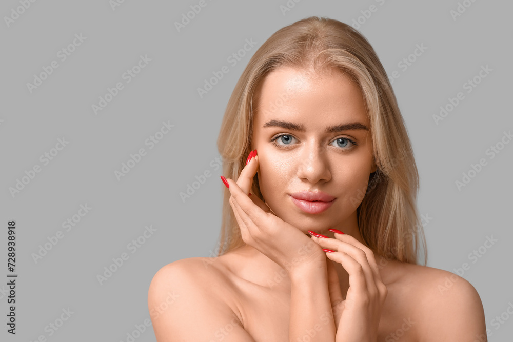 Young woman with beautiful lips on grey background Young woman with beautiful lips on grey background