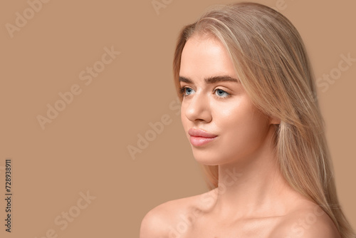 Young woman with beautiful lips on brown background