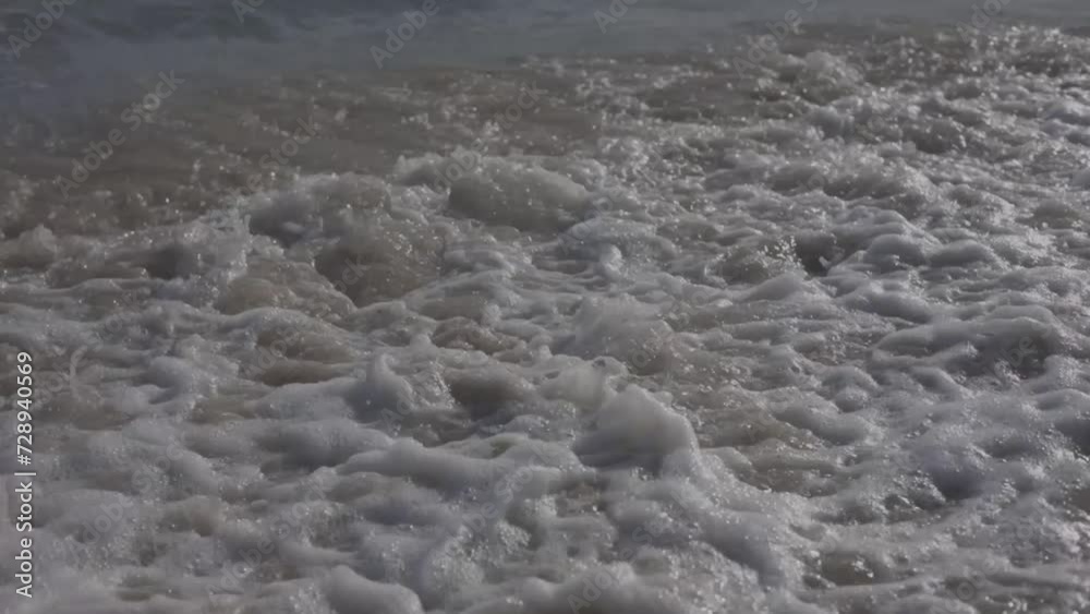 shot of the shore of the beautiful juan dolio beach at sunset, waves moving on the warm sand, beautiful detail in slow motion. HD shot of the shore of the beautiful juan dolio beach at sunset, waves moving on the warm sand, beautiful detail in slow motion. HD