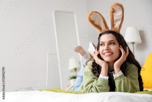 Young woman in bunny ears l...