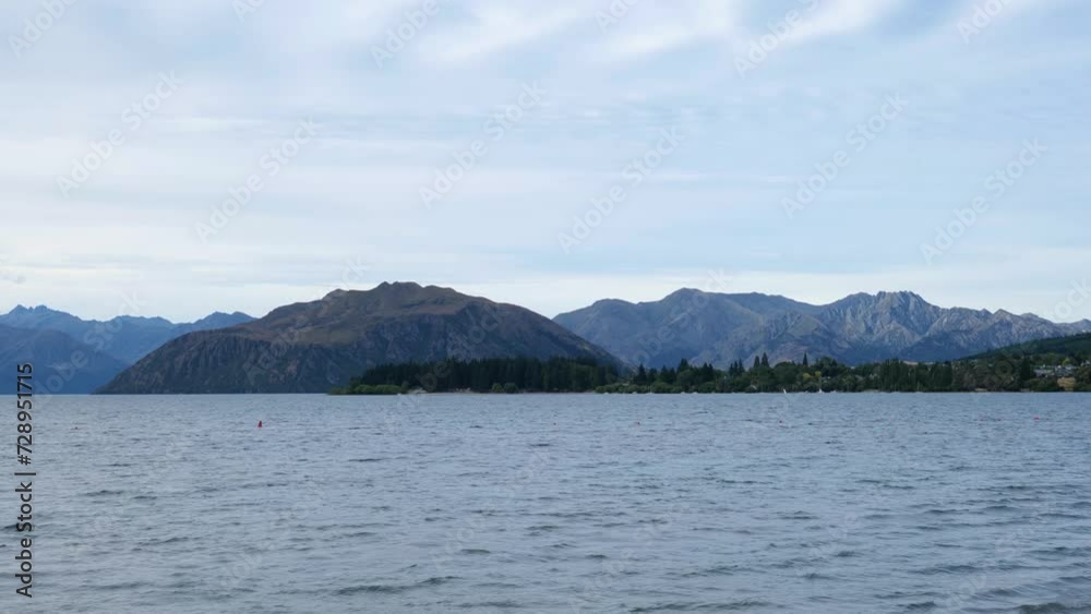 Wanaka lake at the evening, with the mountains behind, New Zealand Wanaka lake at the evening, with the mountains behind, New Zealand