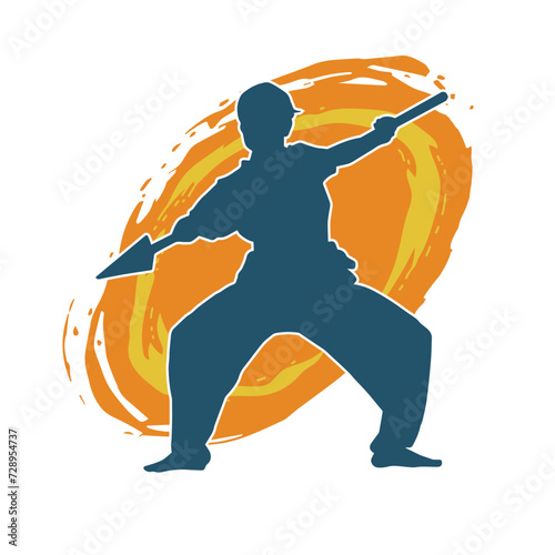 Silhouette of a wushu martial artist in action pose with a spear weapon. Silhouette of a fighter carrying a spear weapon.
