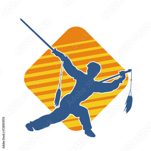 Silhouette of a kungfu or wushu martial art athlete in action pose. Silhouette of a male martial art person in pose with swords weapon.