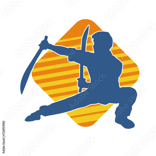 Silhouette of a kungfu or wushu martial art athlete in action pose. Silhouette of a male martial art person in pose with swords weapon.