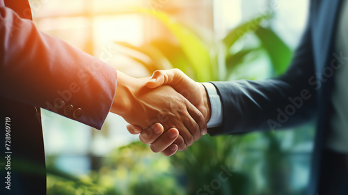 Close-Up of Two Business People Shaking Hands in Office Building During Daytime