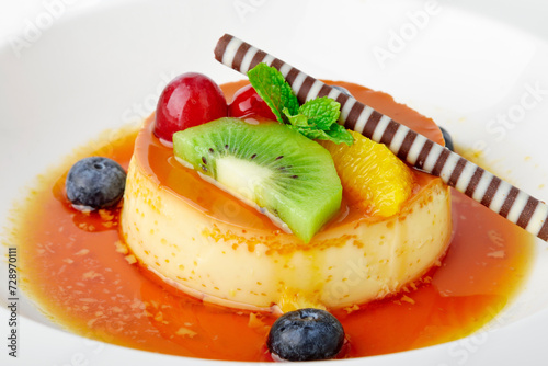 Delilious dessert Caramel custard on top with fruits photo