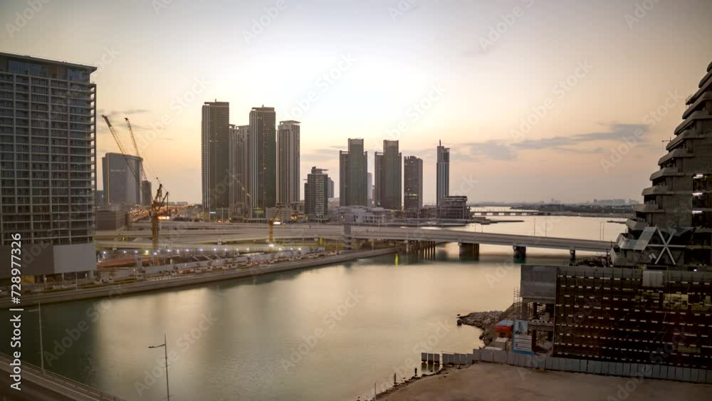 Abu Dhabi, United Arab Emirates city skyline during a golden sunrise - time lapse, cloudscape, Al Reem Island, Al Maryah