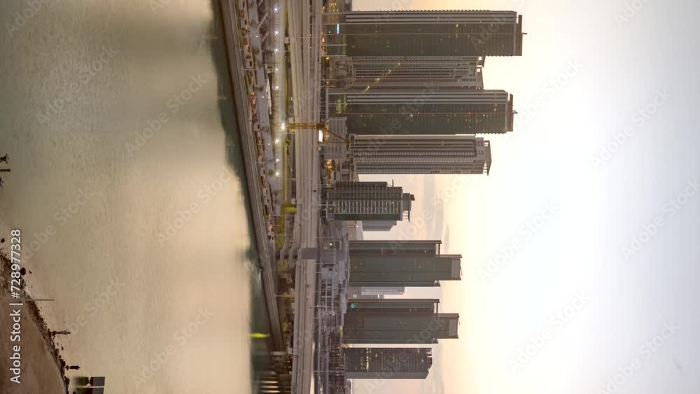Abu Dhabi, United Arab Emirates city skyline golden sunrise time lapse - vertical orientation