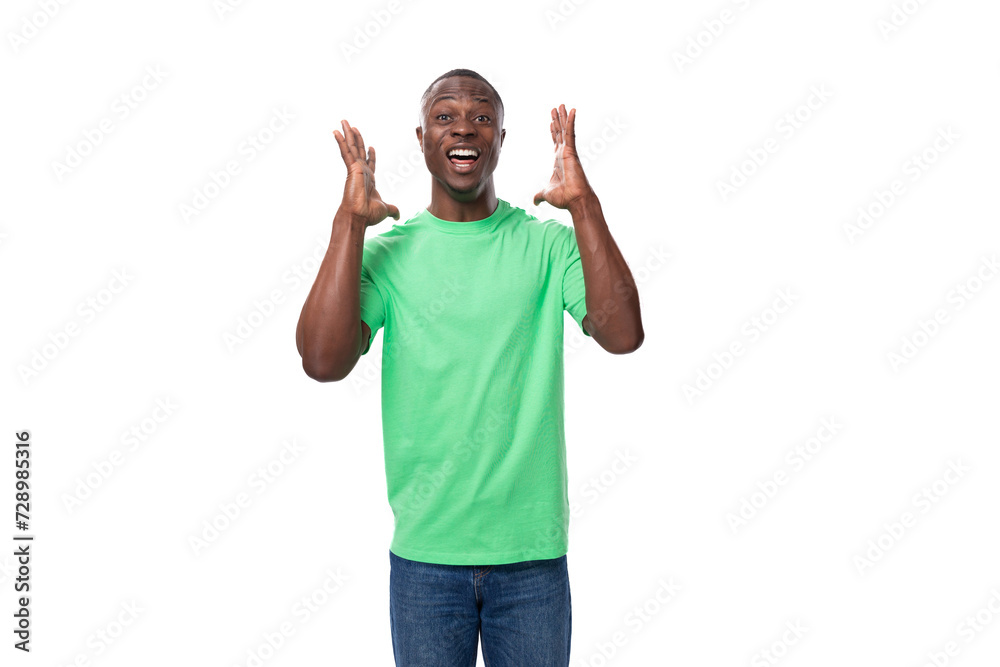 Fototapeta premium a handsome 30 year old african man dressed in a light green basic t-shirt has a strategy