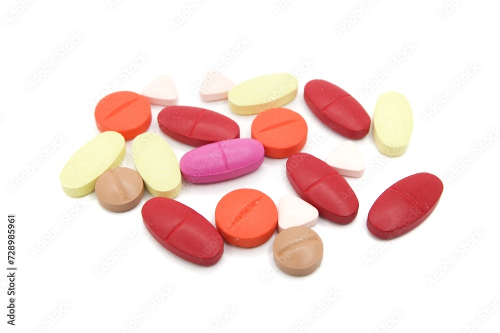 Detailed photos of oval, round and triangular shaped tablets in various colors: red, orange, yellow and cream. The photo was taken on a white background Detailed photos of oval, round and triangular shaped tablets in various colors: red, orange, yellow and cream. The photo was taken on a white background