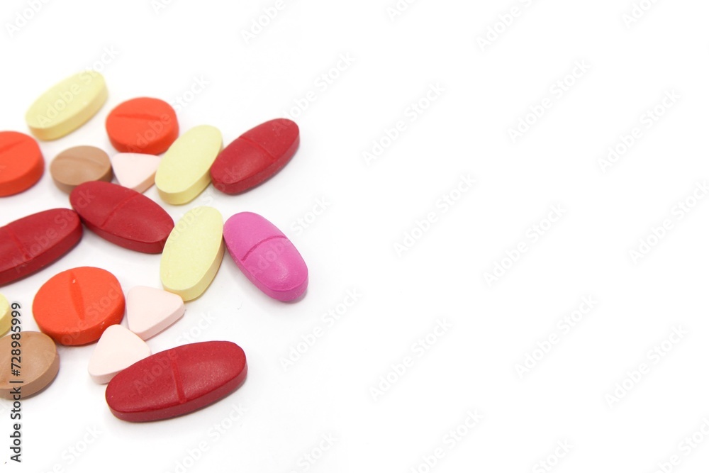 Detailed photos of oval, round and triangular shaped tablets in various colors: red, orange, yellow and cream. The photo was taken on a white background Detailed photos of oval, round and triangular shaped tablets in various colors: red, orange, yellow and cream. The photo was taken on a white background