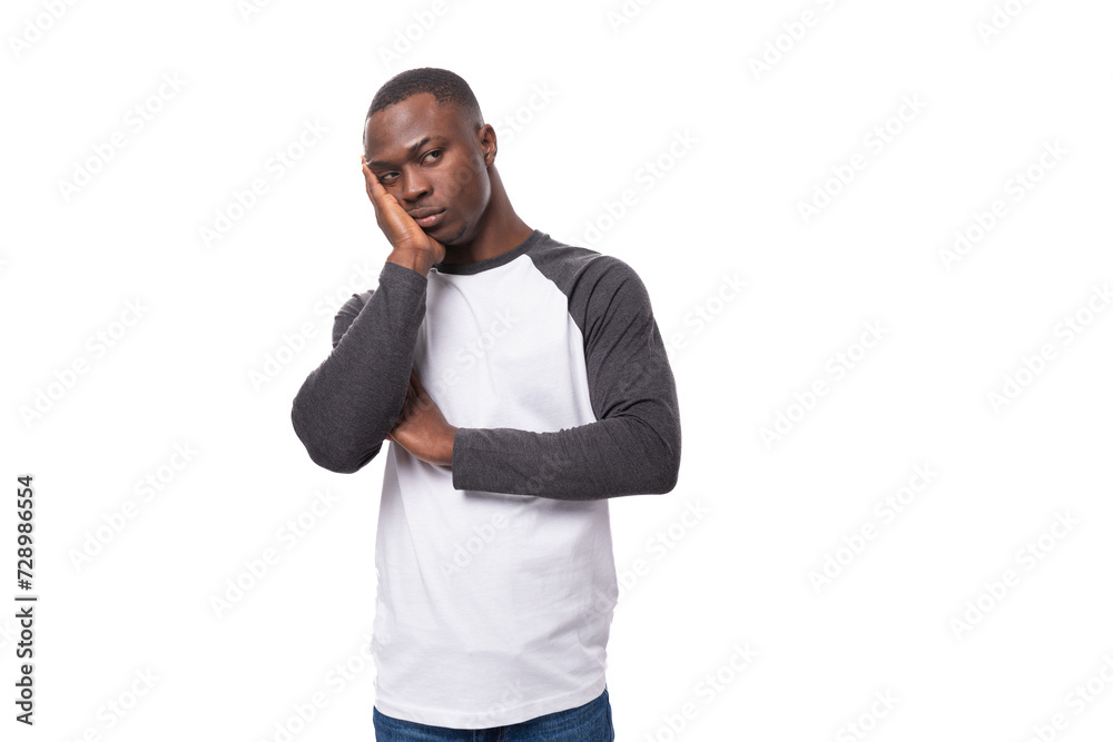 a young african guy with a short haircut wearing a long-sleeved summer sweater is feeling sad a young african guy with a short haircut wearing a long-sleeved summer sweater is feeling sad