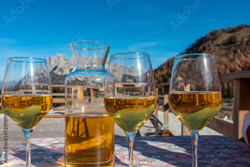 White wine carafe and glasses with scenic view of majestic ridges of Carnic Alps, Friuli Venezia Giulia, Veneto, Italy, Europe. Hiking Sella di Razzo, Sauris di Sopra. Tranquil atmosphere Italian Alps
